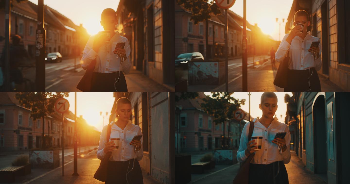 年轻女子日落时在城市里散步，带走咖啡
