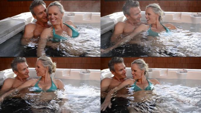 成熟夫妇在热水浴缸里聊天