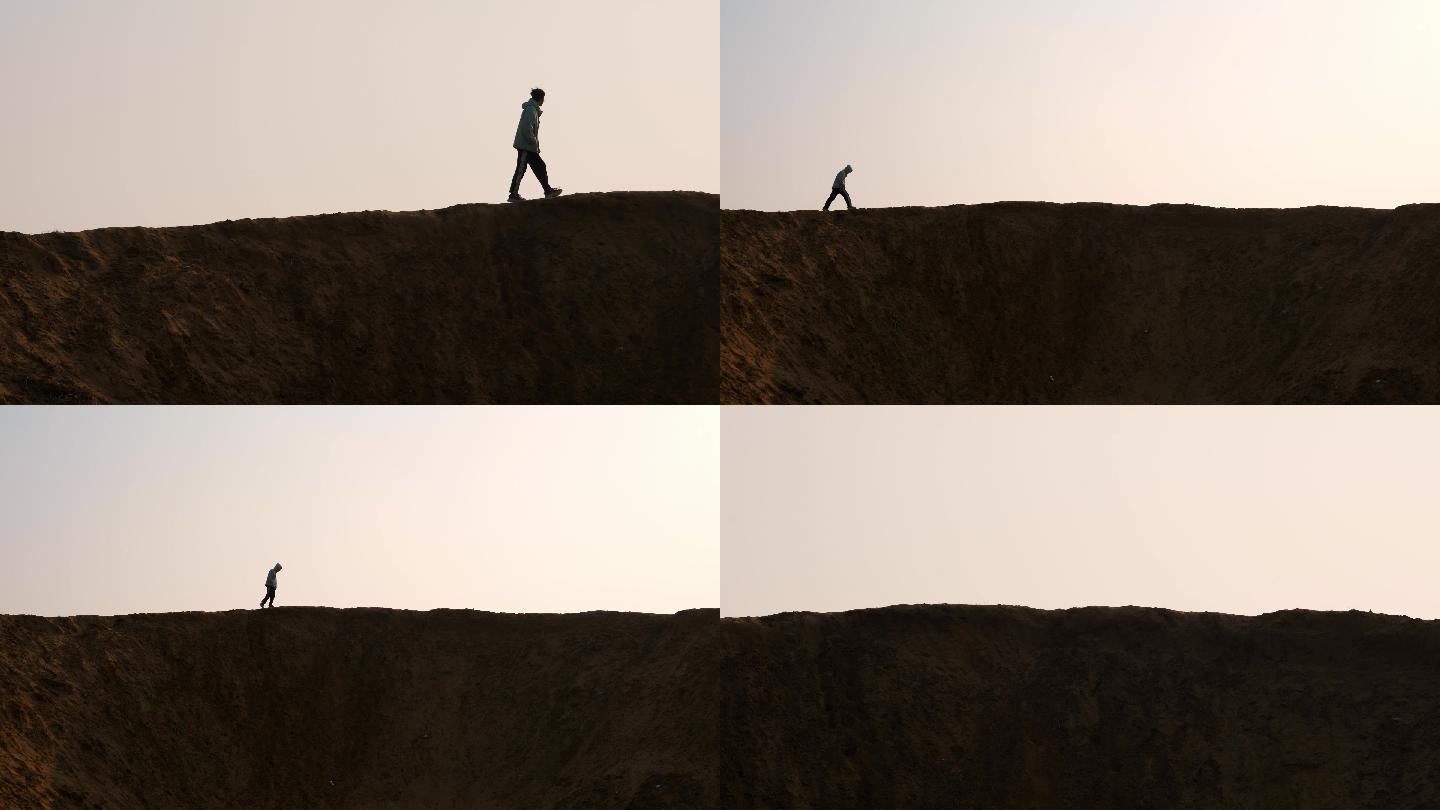 男人行走在苍凉沙漠里的天际线