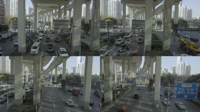 上海交通在高架公路下缓慢行驶的画面。