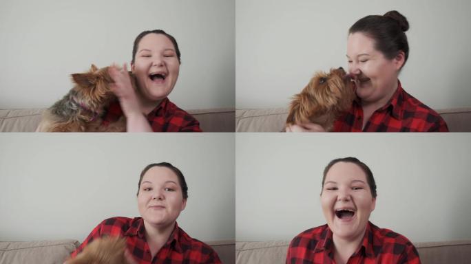 年轻快乐的女孩抱起她的小狗