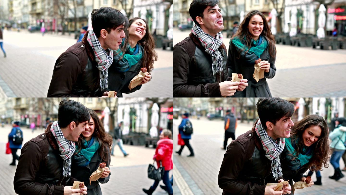 年轻的女人和男人在街上玩得很开心