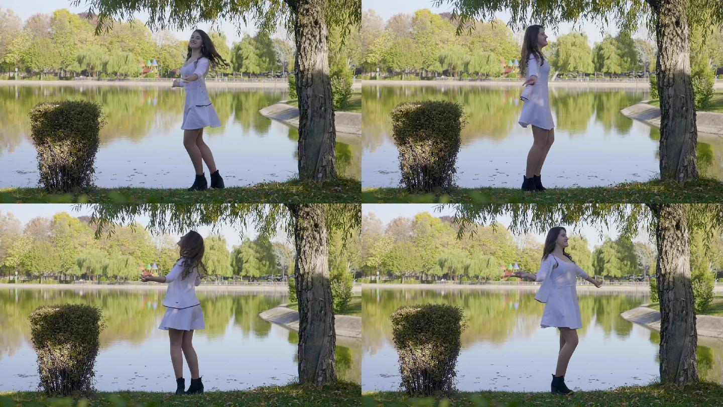 女孩穿着白色的裙子在湖边转圈