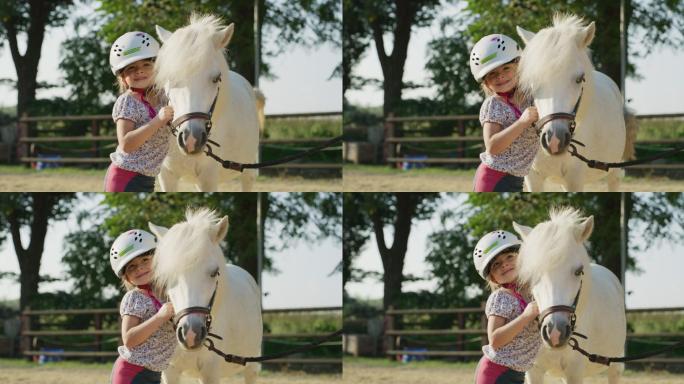 可爱小女孩在爱抚一匹白色小马