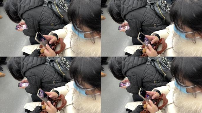 地铁上低头族戴着口罩沉浸式玩手机的年轻人