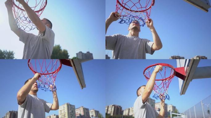 男子在当地的一个球场上安装篮球网。