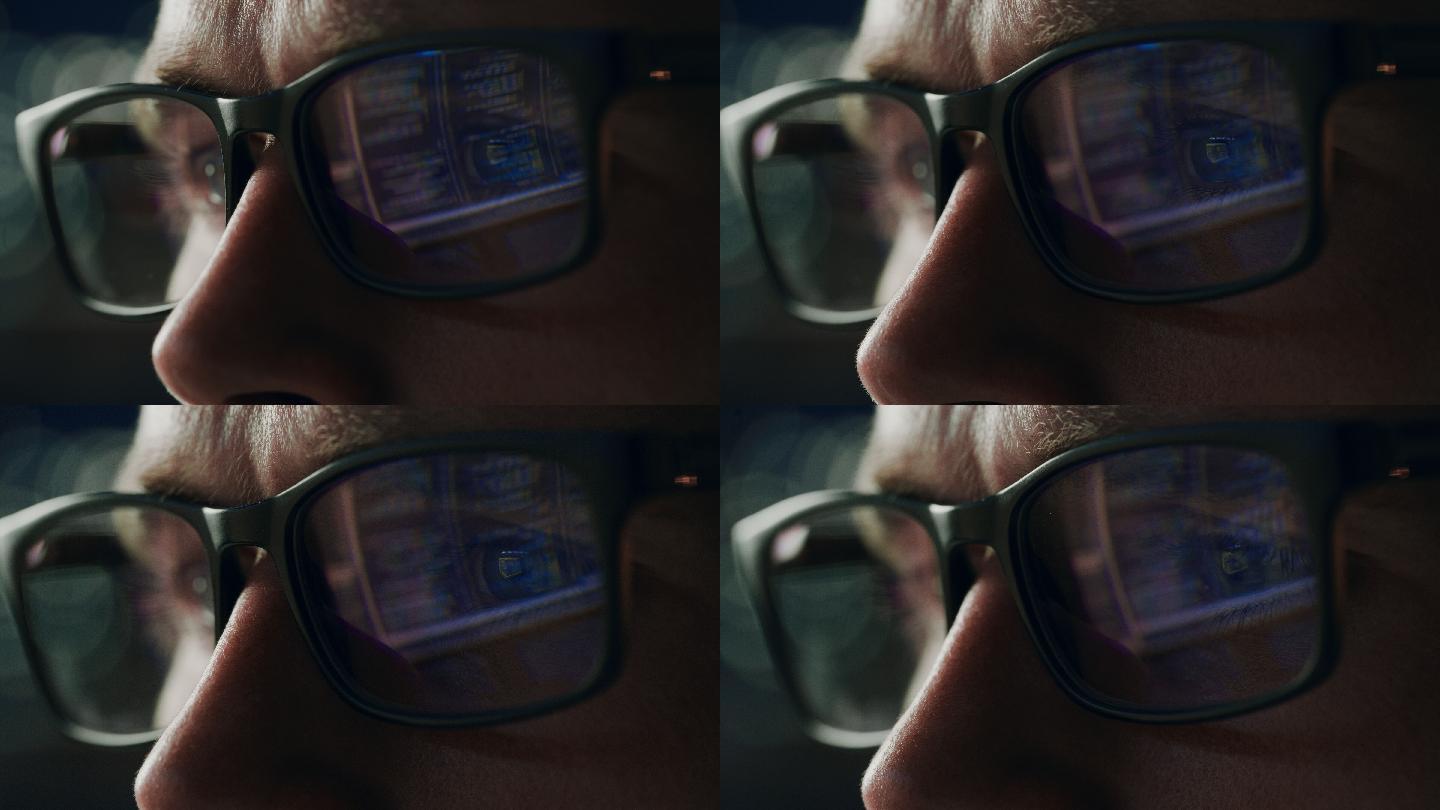 软件工程师在计算机上工作，一行代码反射在眼镜上