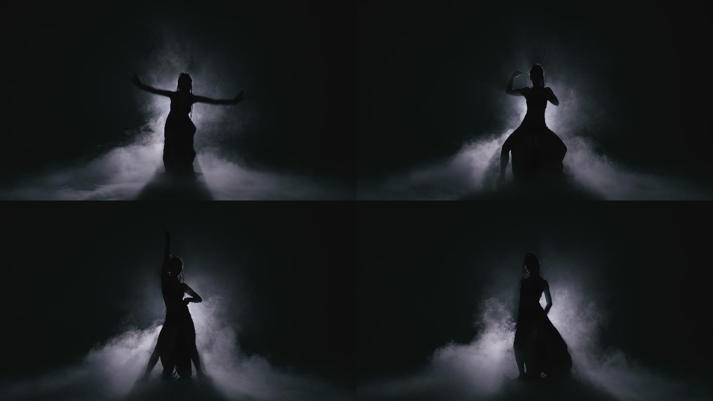剪影舞女在雾中表演