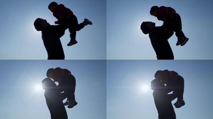 父亲抱起孩子逆光亲吻额头温馨视频父亲节