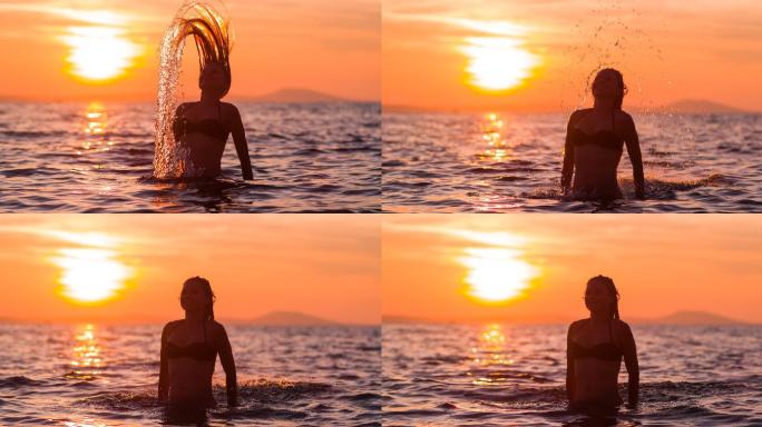日落时留着长发的女人在海里耍水