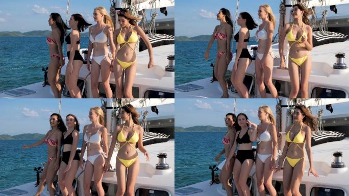 四个美丽的女孩在海上的游艇上跳舞