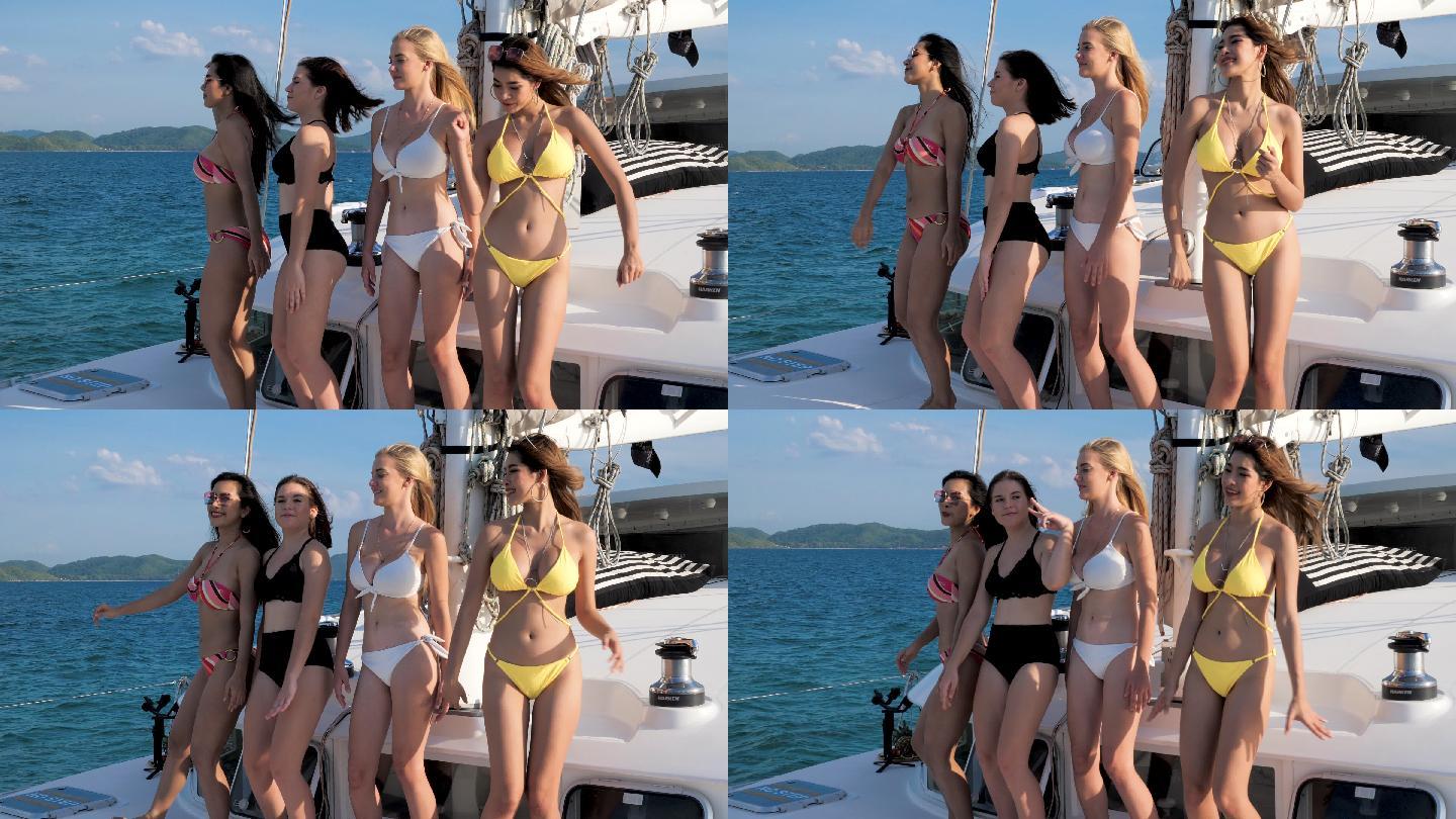 四个美丽的女孩在海上的游艇上跳舞