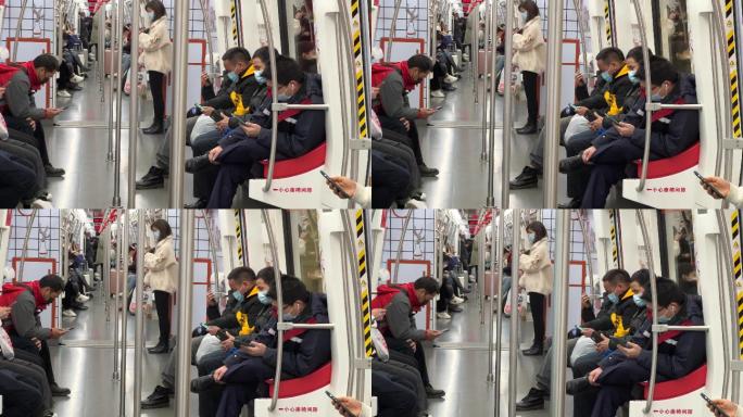 戴口罩坐地铁沉醉式玩手机的低头族人群