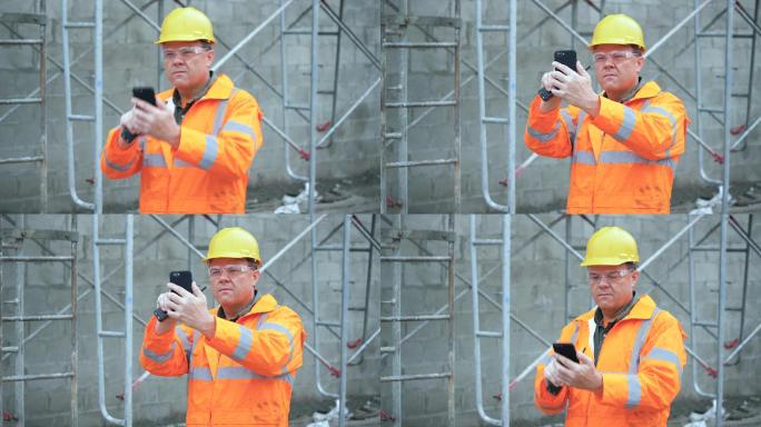 建筑工地男子用手机拍照