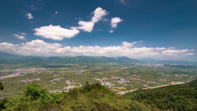 蓝天白云下的夏季山区盆地农村延时摄影