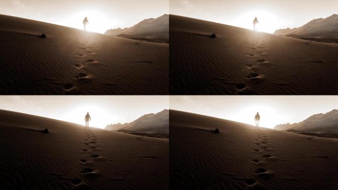 逆光人在沙漠中行走