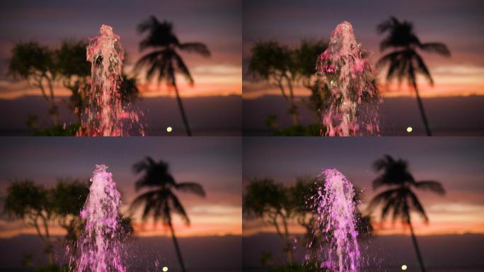 夕阳背景下喷溅彩色喷泉的聚焦镜头