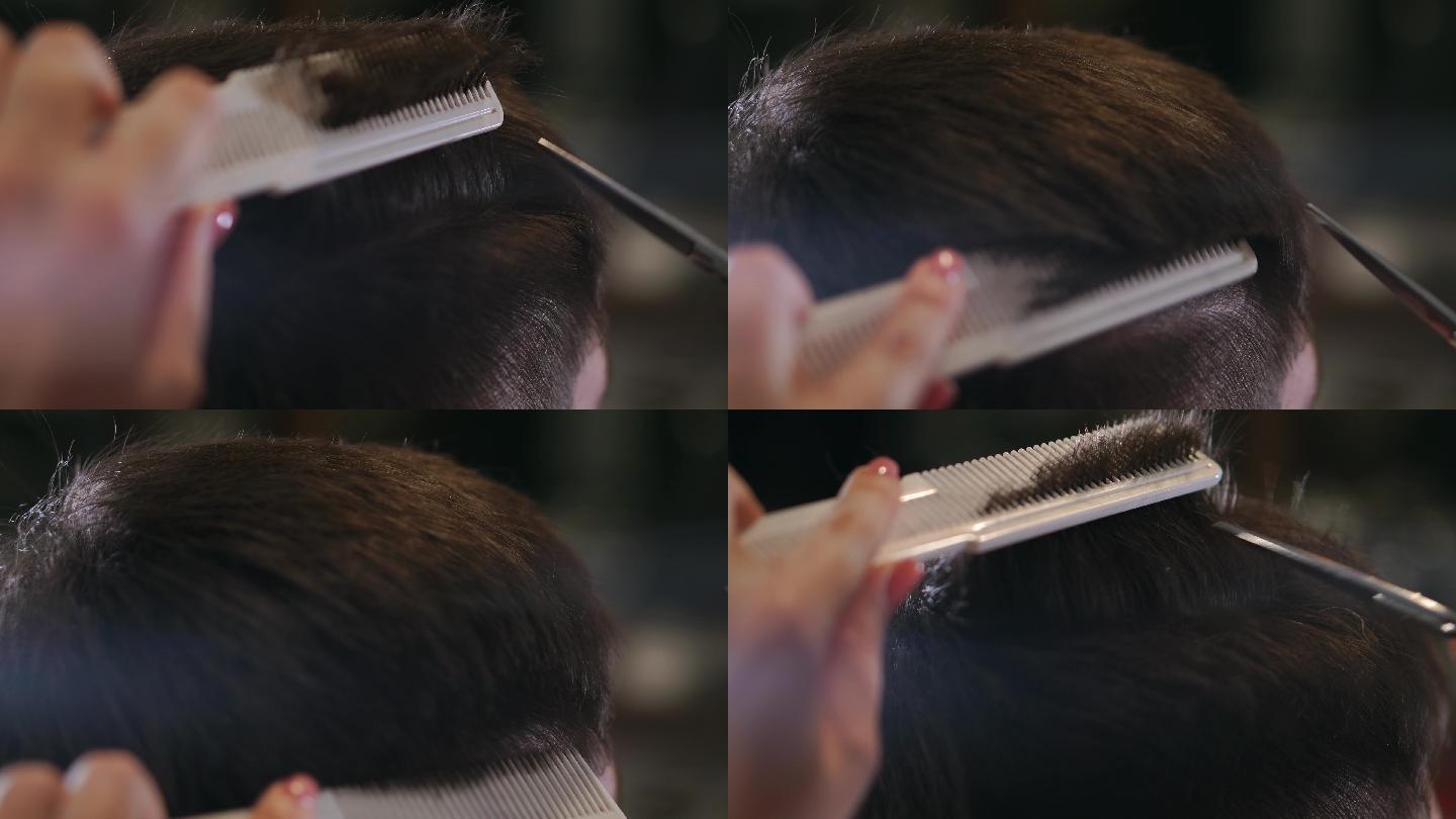 美发师用剪刀和梳子做发型。