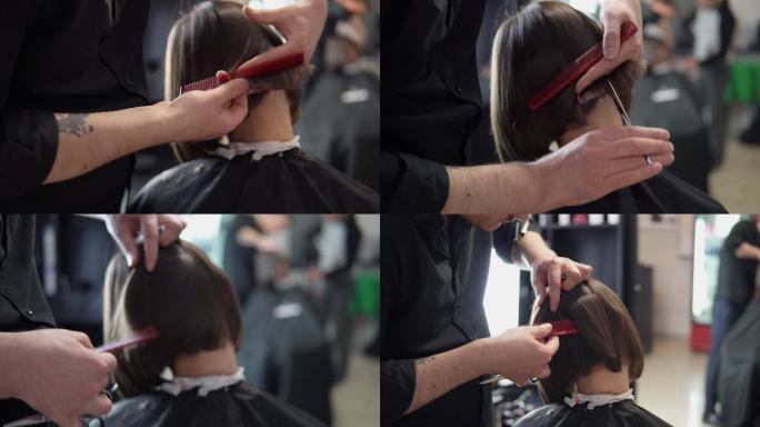 一名理发师在专业美发沙龙为年轻女子理发