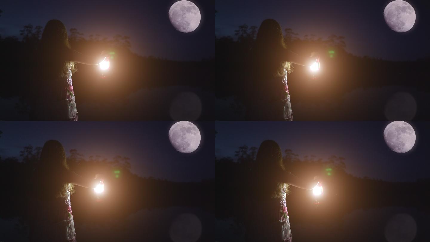 女孩拿着提灯，看着月亮。