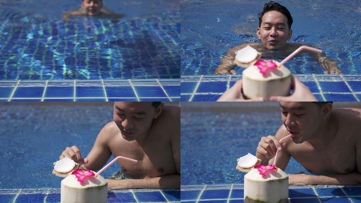 男子在游泳池游泳，喝椰子汁