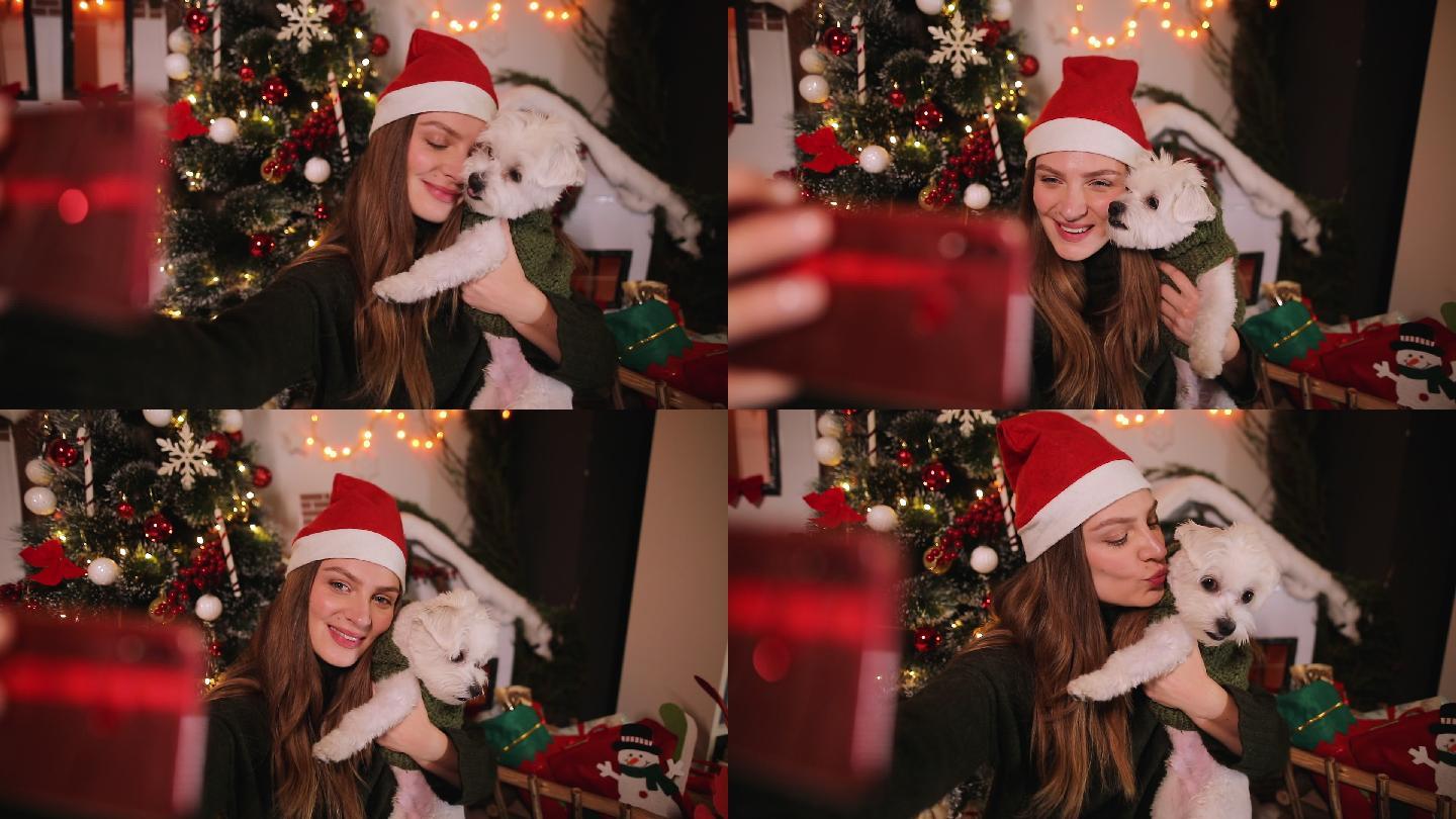 圣诞节期间，女子在家里和她的狗自拍
