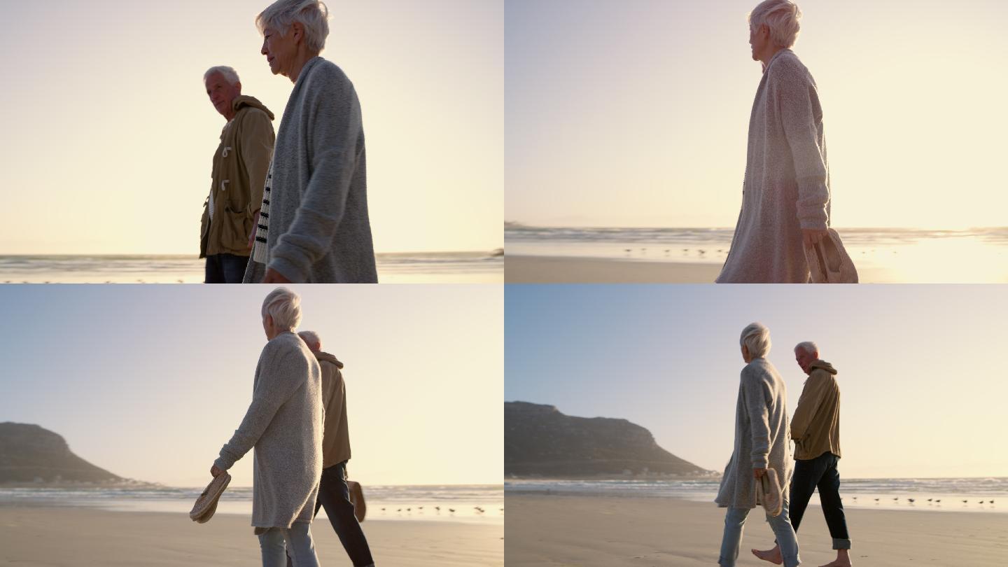 一对老年夫妇沿着海滩散步