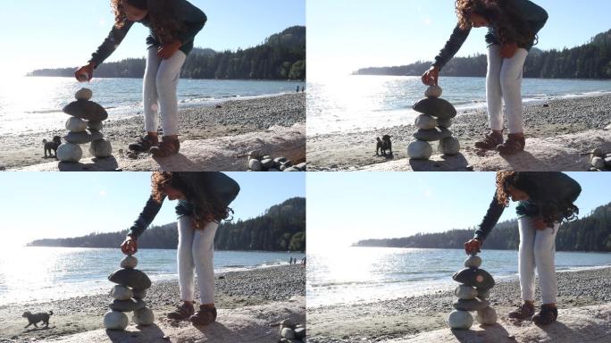 小女孩在石头上继续搭建石头
