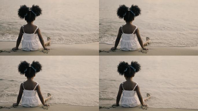 坐在海边的小女孩外国黑人小孩