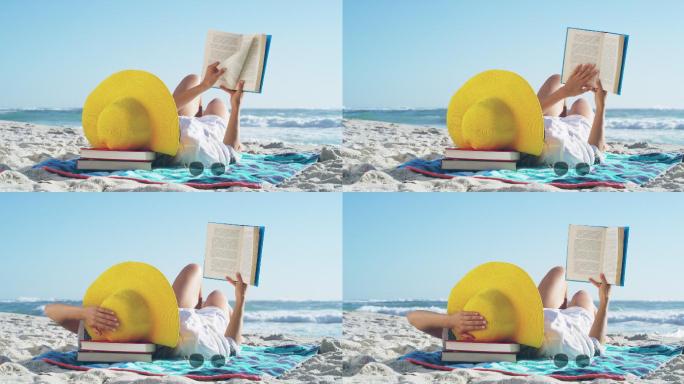 沙滩上看书的女子休闲度假躺在海滩上看书惬