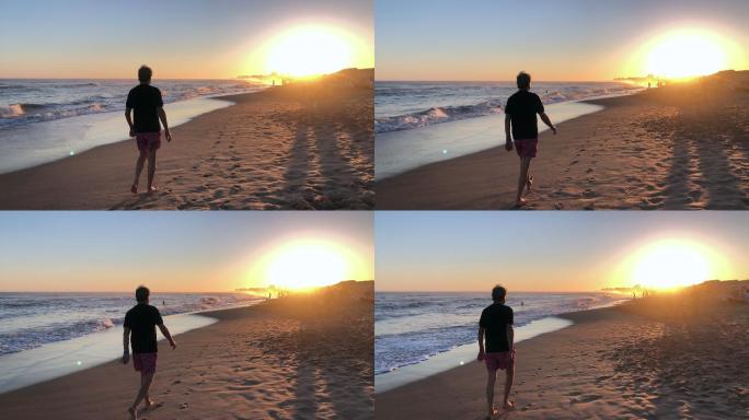 日落时在海滩散步的人