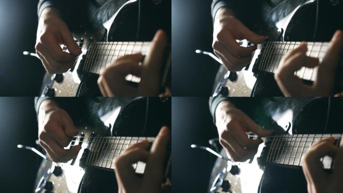 演奏电吉他的男音乐家的手。