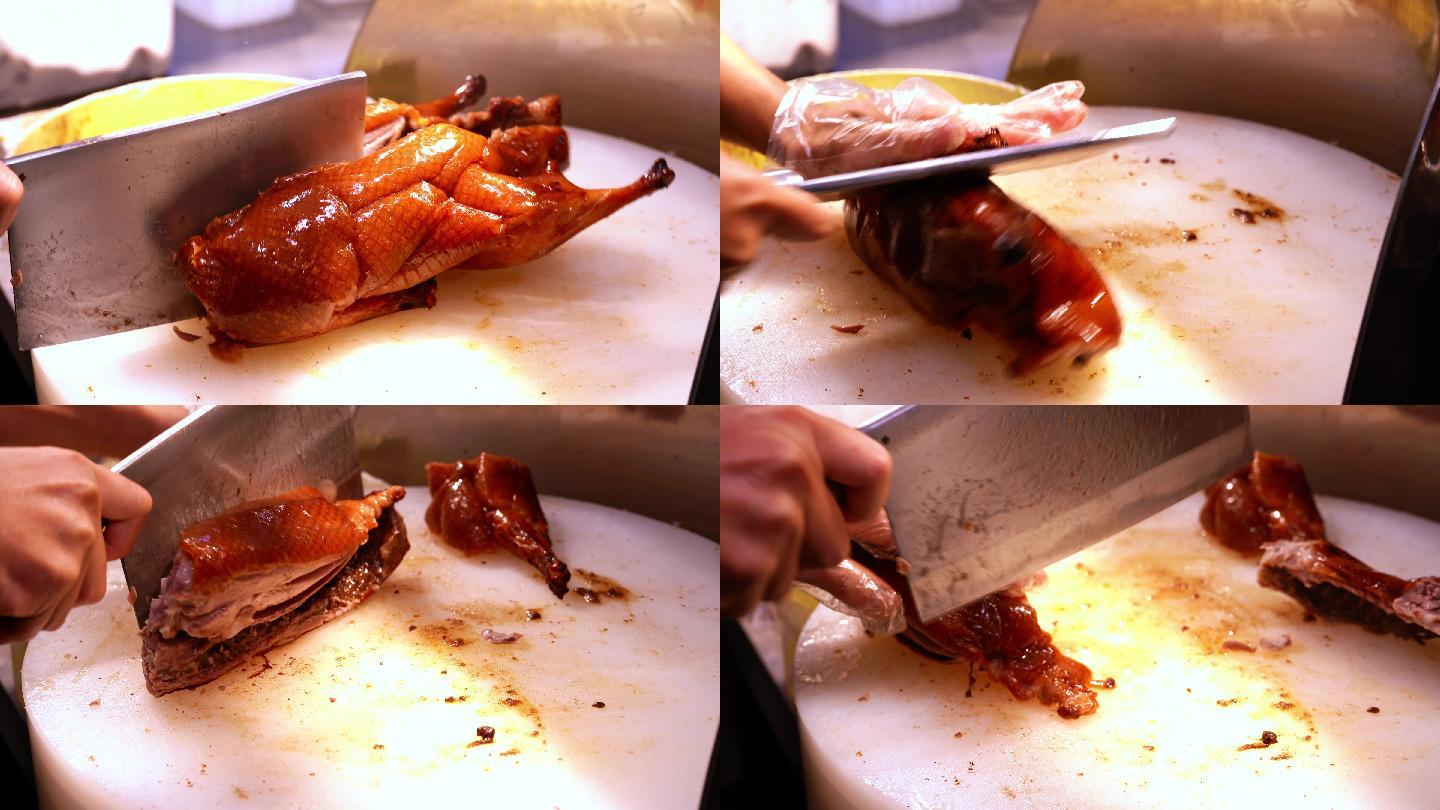 广东烧腊店里的厨师在切一只新鲜的烧鸭