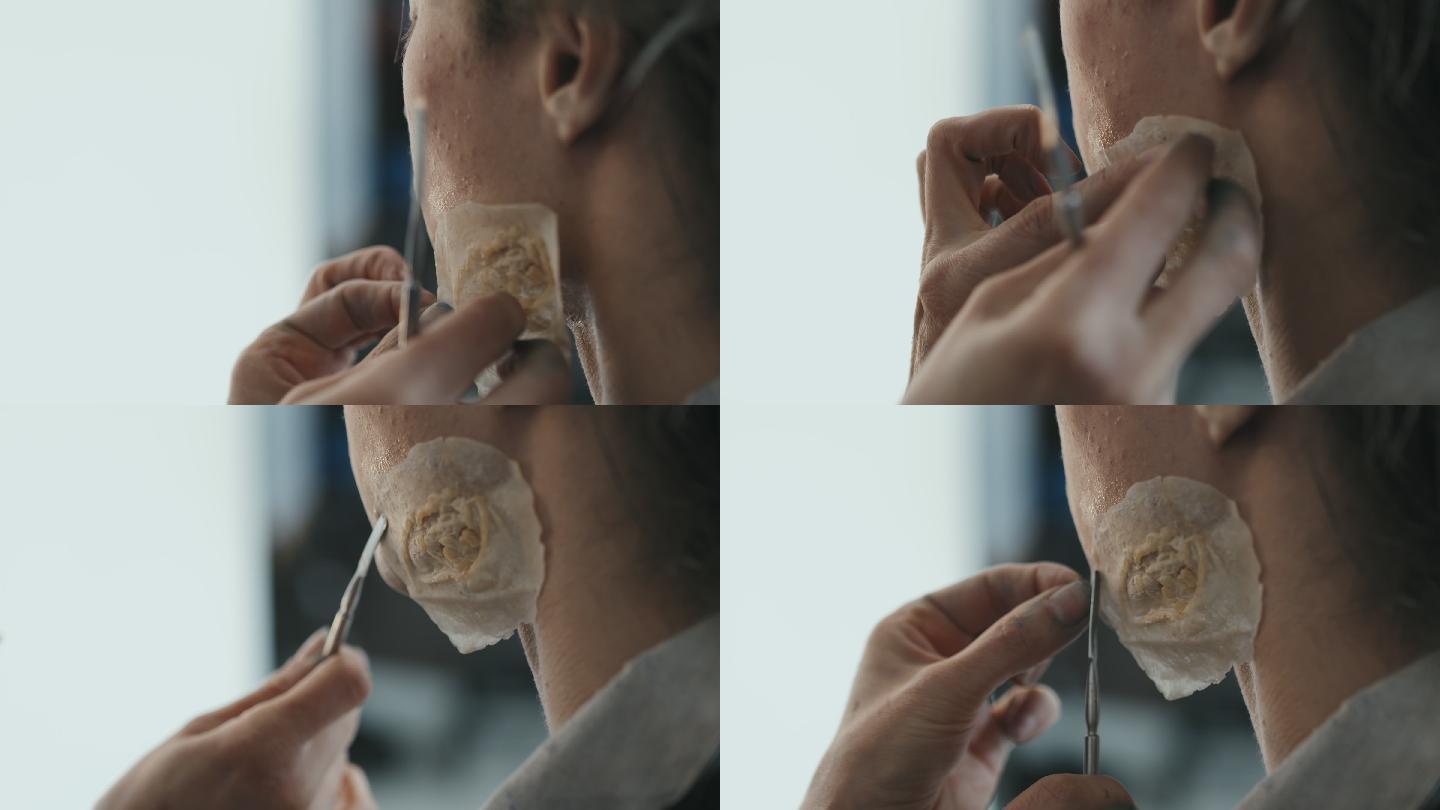 化妆师在男演员脸上涂抹修复疤痕的特写镜头