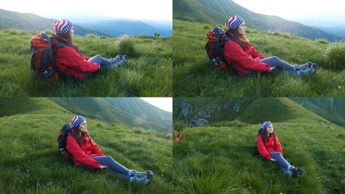 女孩在山上的草地上休息