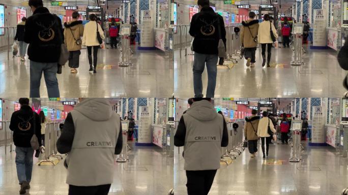 地铁站走向安检入口的一对时尚恋人