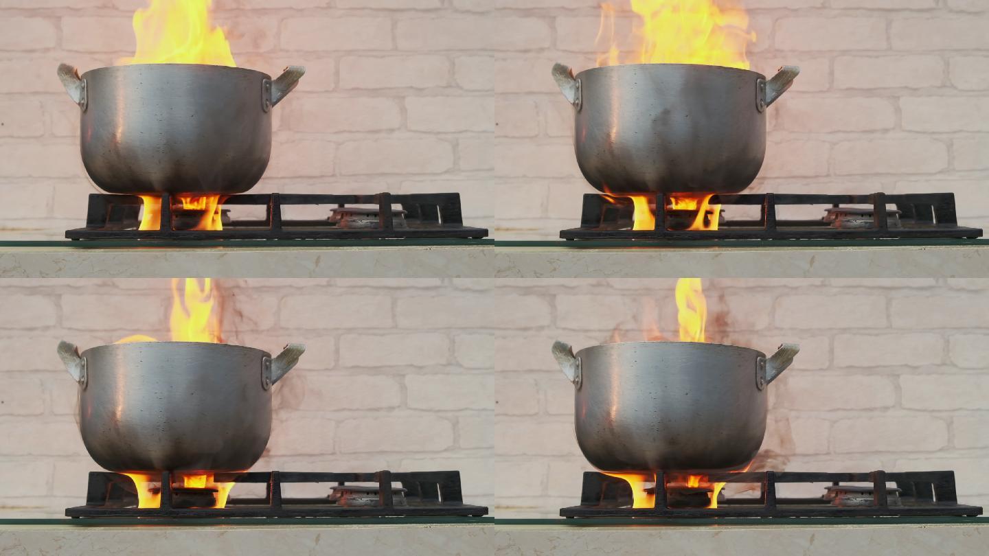 煤气炉上的烹饪锅。家庭火灾原因概念。