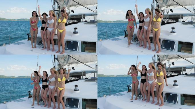 游艇上的女孩们穿着泳装放松跳舞。