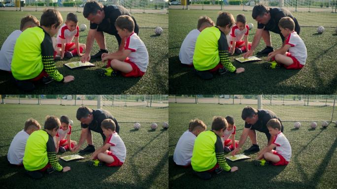 少年足球队教练向孩子们展示比赛方案