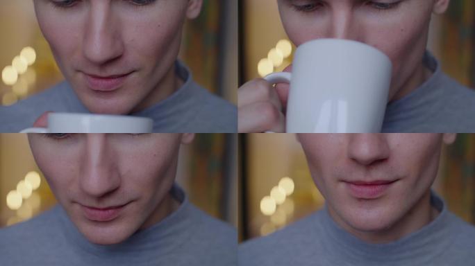 男子用白色杯子喝着茶