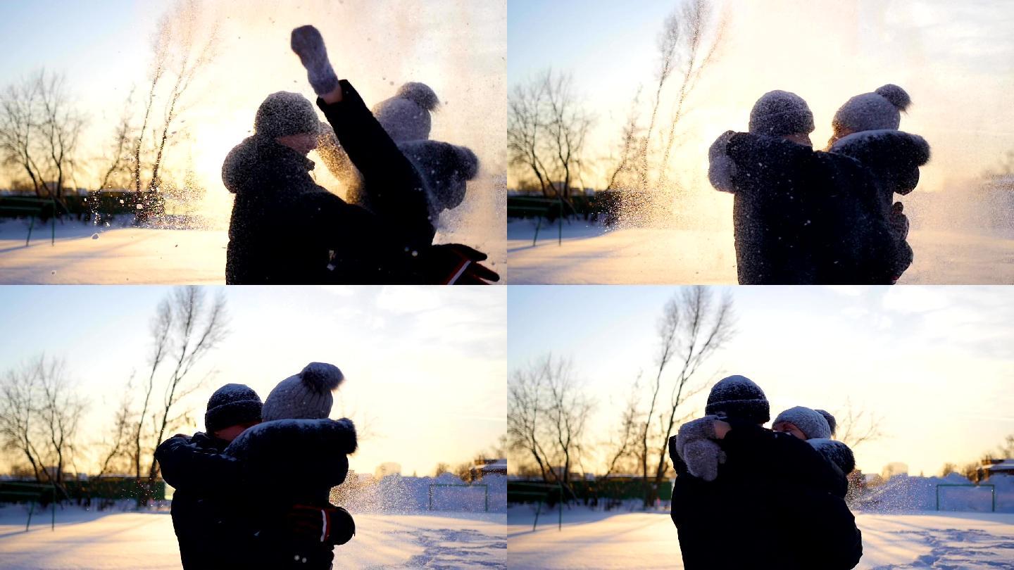 一个男孩和一个女孩把雪扔到头上拥抱