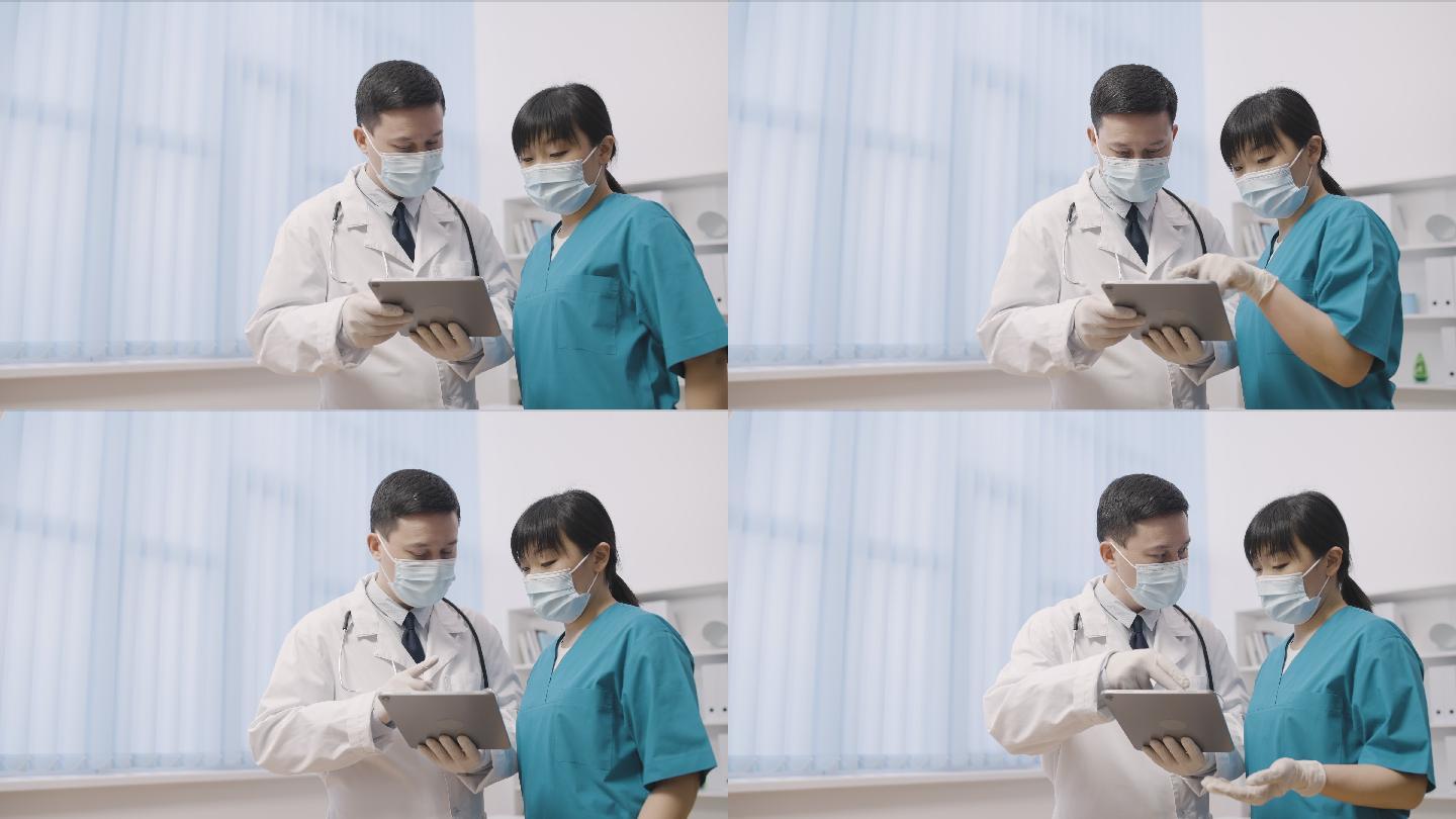 男性和女性医生看着平板电脑，讨论问题