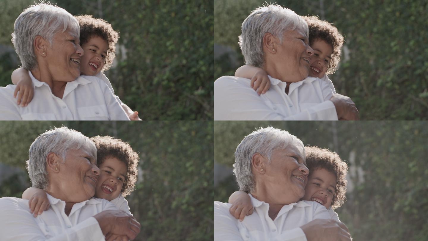 一个小男孩从背后拥抱祖母