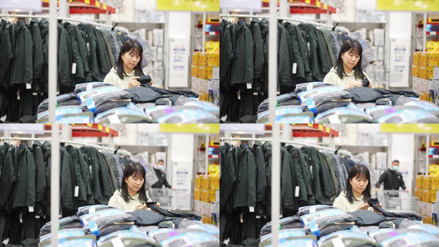 年轻女性在超市里选购货物衣服