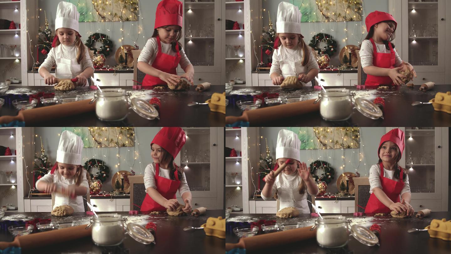 两个可爱的小女孩厨师在揉生面做姜饼饼干