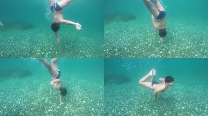 男孩潜入透明的海水中