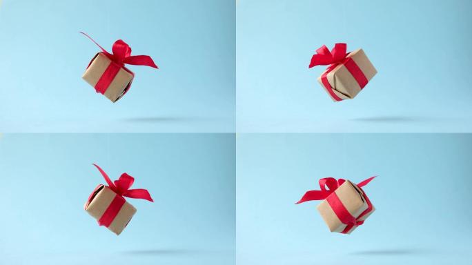 红色丝带在背景上旋转的礼品盒