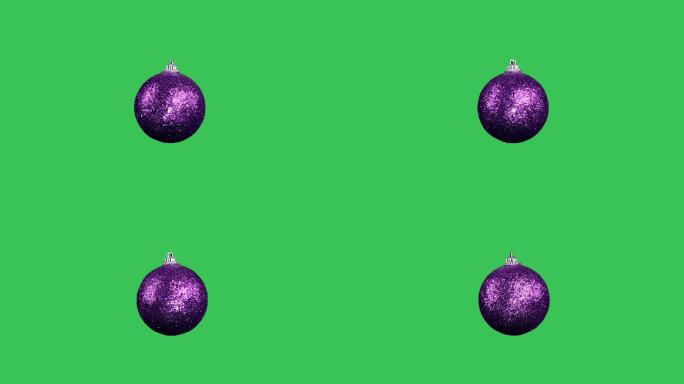 在绿色屏幕上的紫色圣诞球