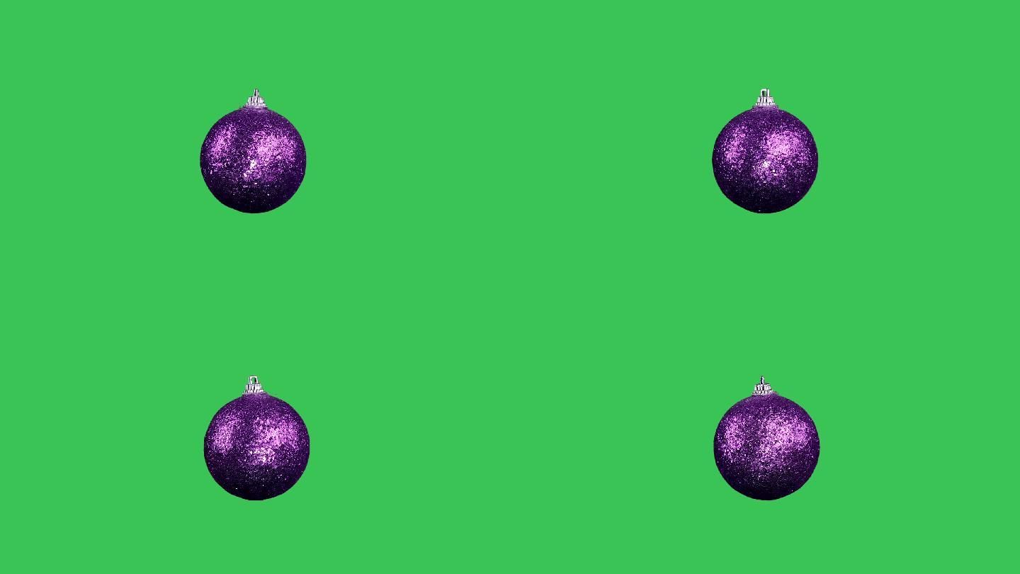 在绿色屏幕上的紫色圣诞球