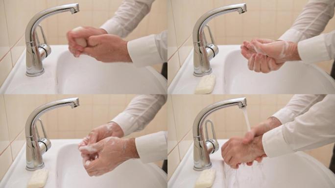 在洗手盆的流水下用肥皂洗手